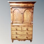 A Victorian mahogany double door linen press fitted with four drawers