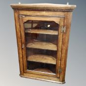 A Georgian oak glazed corner cabinet
