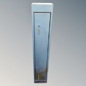 A metal gun cabinet with keys