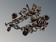 A white metal charm bracelet, 79.9g.