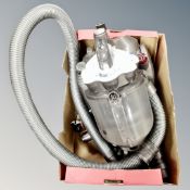 A Dyson cylinder vac with hose and accessories