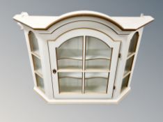 A cream and gilt glazed wall cabinet,