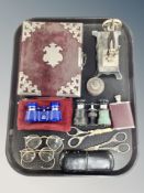 A tray of Victorian photograph album of monochrome photographs, tin plate toy sewing machine,