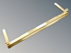 A brass extending fire curb.
