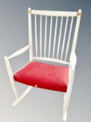 A Scandinavian cream spindle backed rocking chair