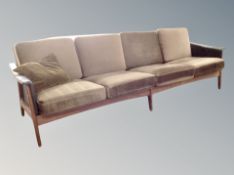 A Scandinavian teak and black vinyl four seater settee with brown dralon cushions