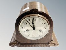 An oak cased mantel clock.