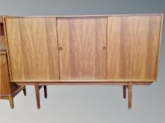 A Scandinavian teak sideboard on raised legs,
