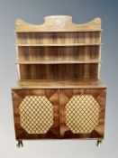 A Regency style rosewood chiffonier with brass mounted waterfall shelves ,