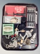 A tray of assorted vintage and later bottle openers, wine bottle thermometers,
