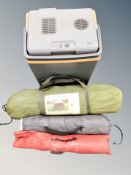 A cooler containing camping equipment