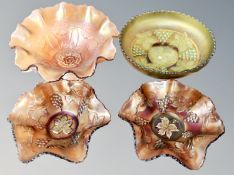 Four pieces of Carnival glass, antique green Fenton grape and cable footed dish,