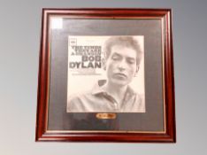 A framed Bob Dylan print.