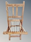 A child's folding armchair carved Bishop K Skelton to back rest