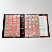 A Schulz coin album (blue) containing eighty collectable 50 pence coins, various dates and themes.