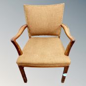 An armchair in studded brown fabric