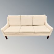 A late 20th century Scandinavian three seater settee in oatmeal fabric,