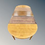 A D-end dining table with three associated leaves,