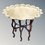 An engraved brass topped occasional table,