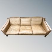 A late 20th century Scandinavian brown leather three seater settee,