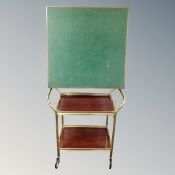 A gilt metal two tier serving trolley with lift off tray,