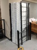 A 3' black metal truckle day bed with interiors