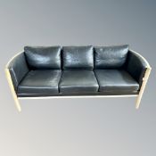 A Scandinavian wood framed black leather three seater settee