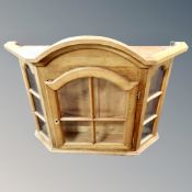A continental oak glazed wall cabinet