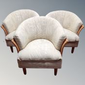 Three bamboo and wicker tub chairs in multi coloured fabric