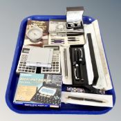 A group of digital calculators, boxed pens, rulers,