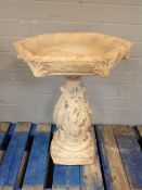 A concrete garden hexagonal topped bird bath on pedestal