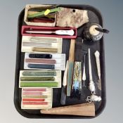 A quantity of coloured wax sticks, oriental hand fans, two pen stands,