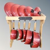 A set of five graduated Le Creuset cast iron lidded sauce pans on stand