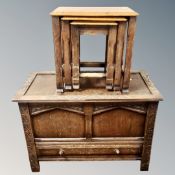 A carved oak offer and a nest of three oak tables