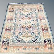 A fringed woolen rug of geometric design,