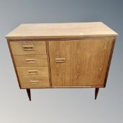 A 20th century teak sewing machine cabinet