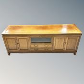 A contemporary Chinese cherry wood four door low sideboard