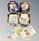 Two tins of Pokemon cards