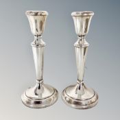 A pair of weighted silver candlesticks,