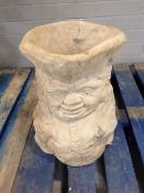 A concrete garden toby jug planter