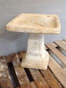 A concrete garden square topped rose bird bath on pedestal