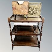 An Edwardian oak tea trolley, brass embossed magazine rack,