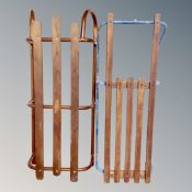 Two vintage wooden slatted sledges on metal runners