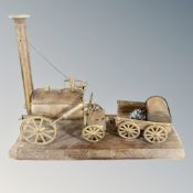 A brass model of Stephenson's Rocket on plinth