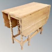 A 20th century oak pie crust edge drop leaf table