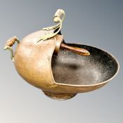 A Victorian copper and brass coal helmet with shovel,