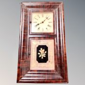 A 19th century American wall clock with pendulum and weights