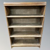 An Edwardian oak four tier sectional bookcase (no doors)