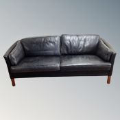 A Scandinavian black leather over-sized two seater settee