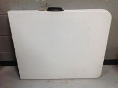 A moulded plastic folding trestle table,